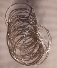 Load image into Gallery viewer, Set of 25 light silver bangles