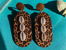 Load image into Gallery viewer, Clip on wood and cowrie animal print earrings
