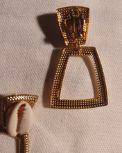 Load image into Gallery viewer, Small Hammered Gold Metal and cowrie shell Clip On Earrings
